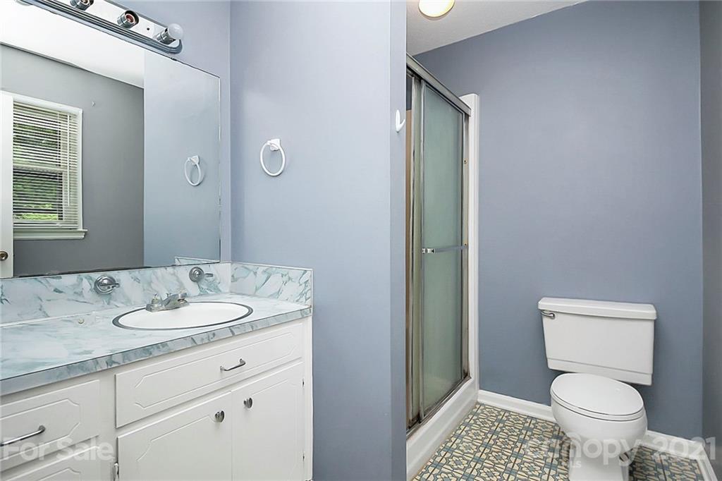 2101 Stallings Road Harrisburg, NC 28075 - Photo 18 of 45 a bathroom with a granite countertop sink toilet and shower