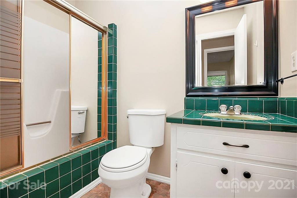 2101 Stallings Road Harrisburg, NC 28075 - Photo 19 of 45 a bathroom with a sink a toilet and shower