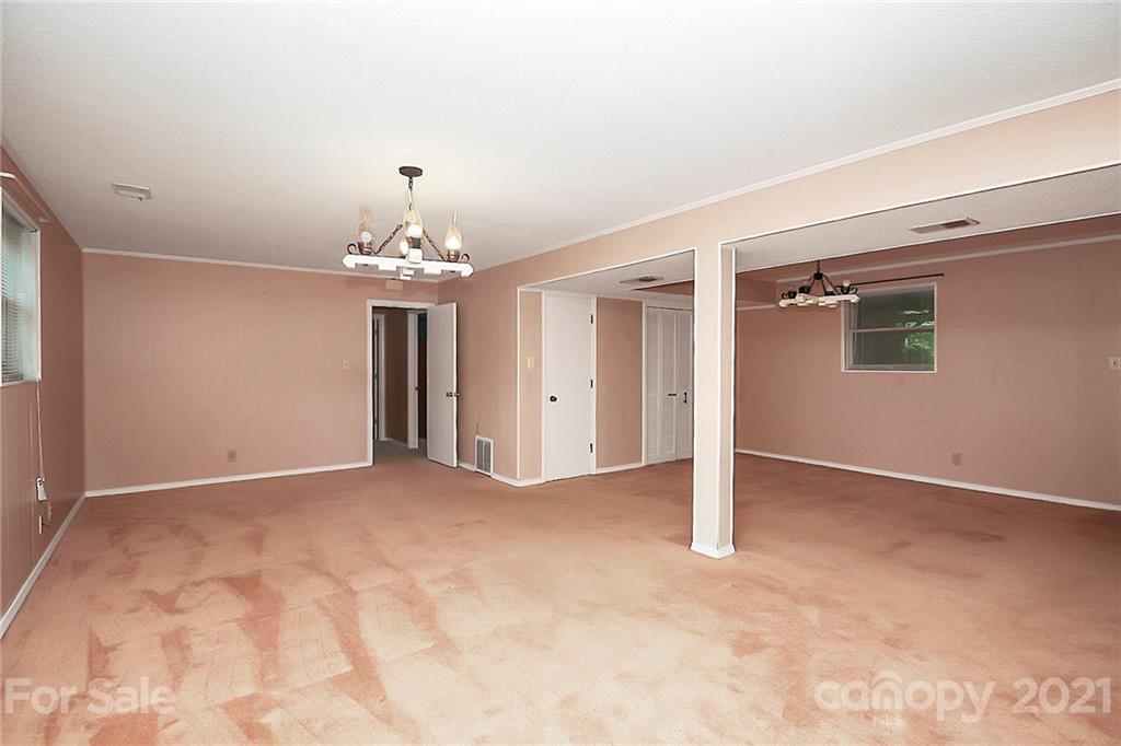 2101 Stallings Road Harrisburg, NC 28075 - Photo 21 of 45 a view of a livingroom with a chandelier fan and windows
