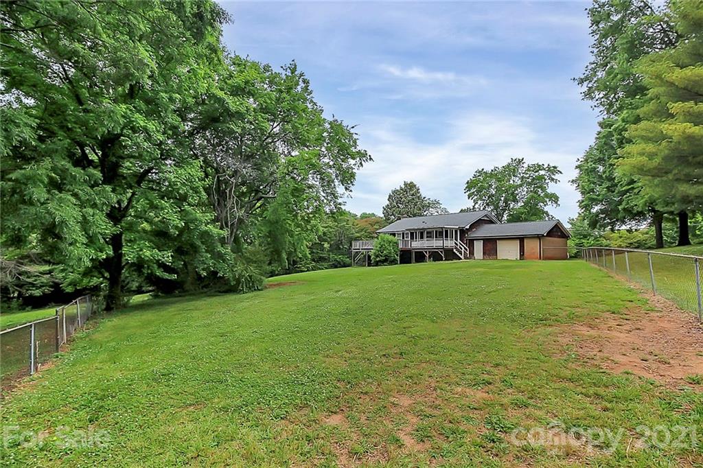 2101 Stallings Road Harrisburg, NC 28075 - Photo 28 of 45 a view of a house with a yard and a garden