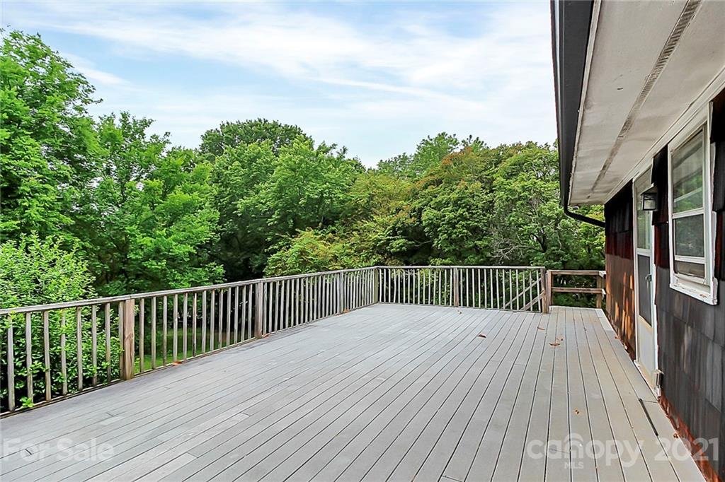 2101 Stallings Road Harrisburg, NC 28075 - Photo 32 of 45 a balcony with wooden floor and fence
