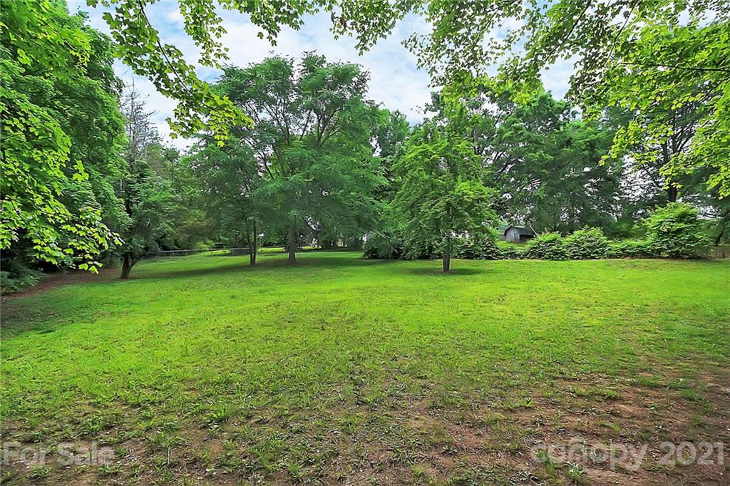 2101 Stallings Road Harrisburg, NC 28075 - Photo 38 of 45 a view of green field with trees in the background