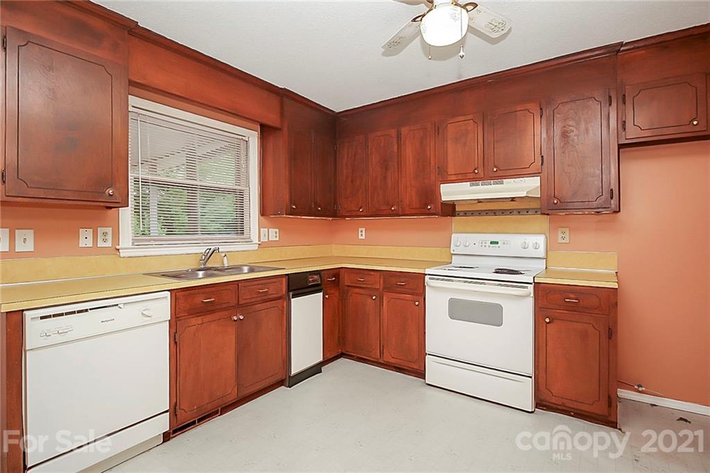 2101 Stallings Road Harrisburg, NC 28075 - Photo 10 of 45 a kitchen with cabinets appliances a sink and a window