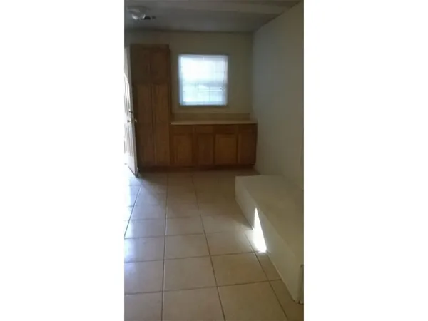 a view of a hallway with bathroom