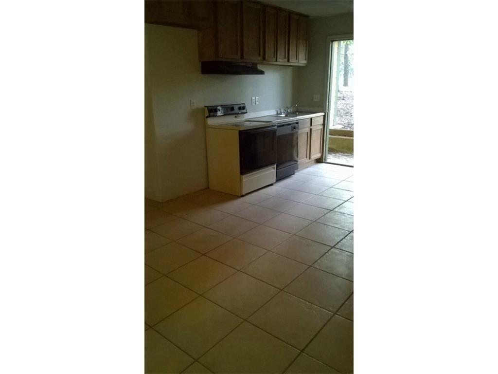 266 James Fannin Road Honey Grove, TX 75446 - Photo 7 of 11 a kitchen with a sink and a stove