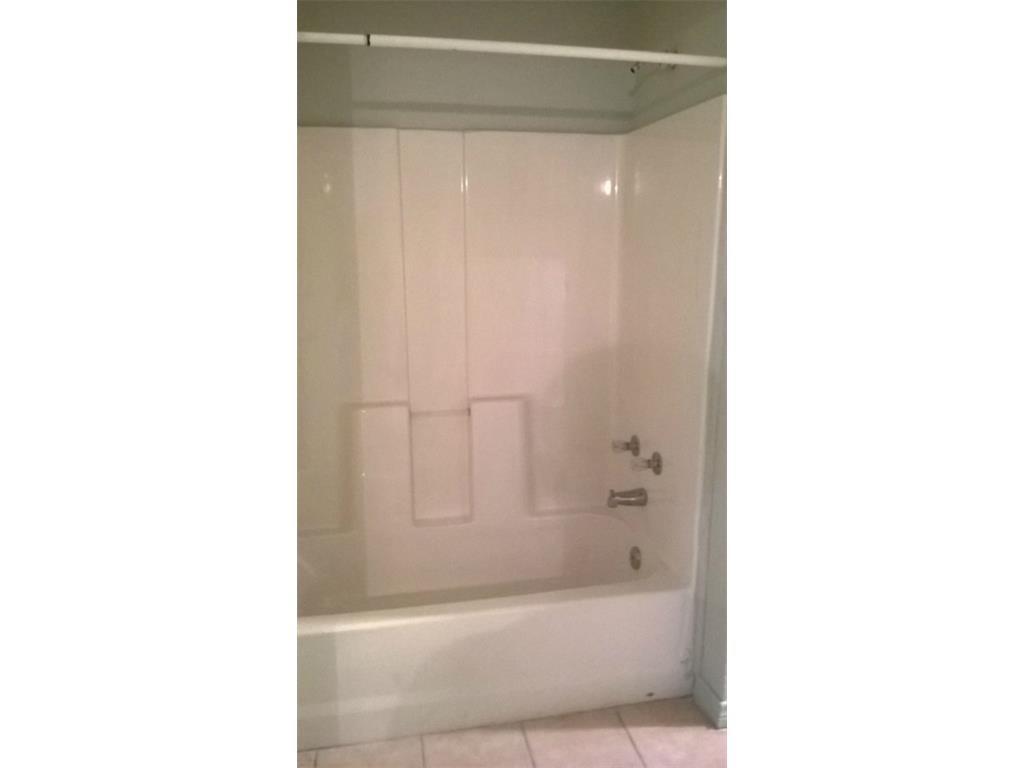 266 James Fannin Road Honey Grove, TX 75446 - Photo 8 of 11 a bathroom with a bathtub and a shower