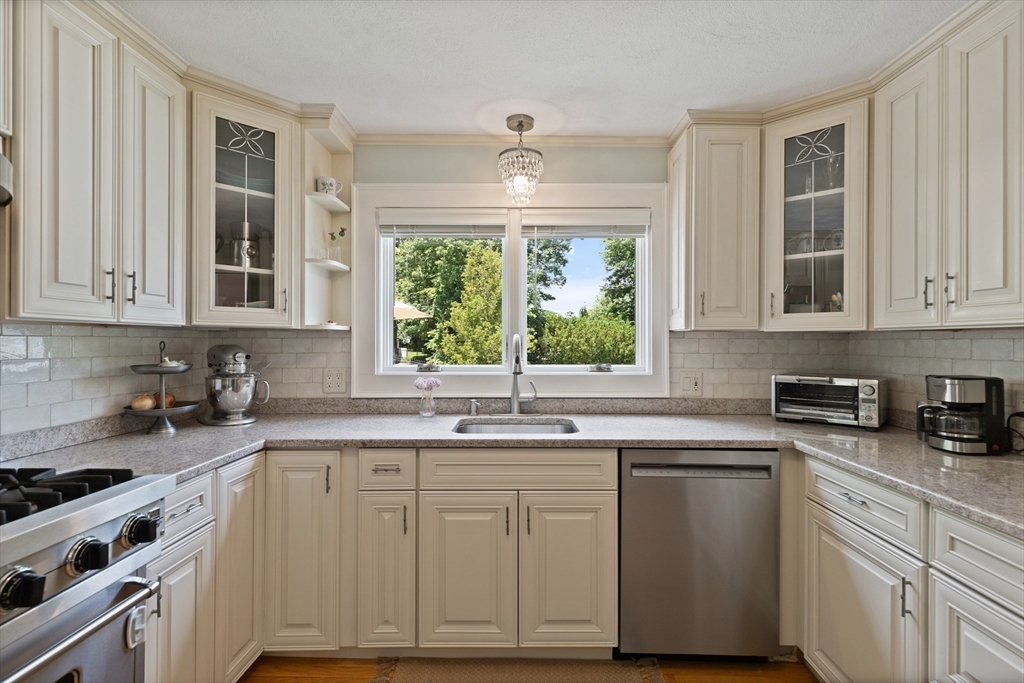 2 Parkwood Road Lynnfield, MA 01940 - Photo 13 of 37 a kitchen with stainless steel appliances granite countertop a sink a stove a cabinets and wooden floors
