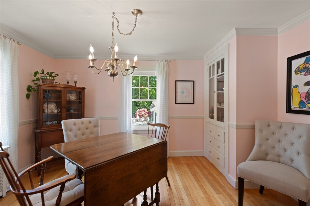 2 Parkwood Road Lynnfield, MA 01940 - Photo 19 of 37 a view of a dining room with furniture and a chandelier