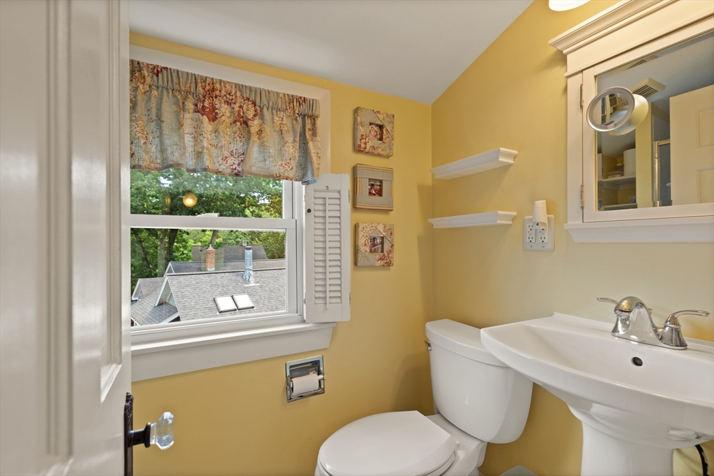 2 Parkwood Road Lynnfield, MA 01940 - Photo 25 of 37 a bathroom with a toilet sink and mirror