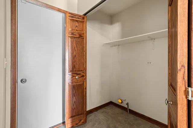 a view of walk in closet with empty racks