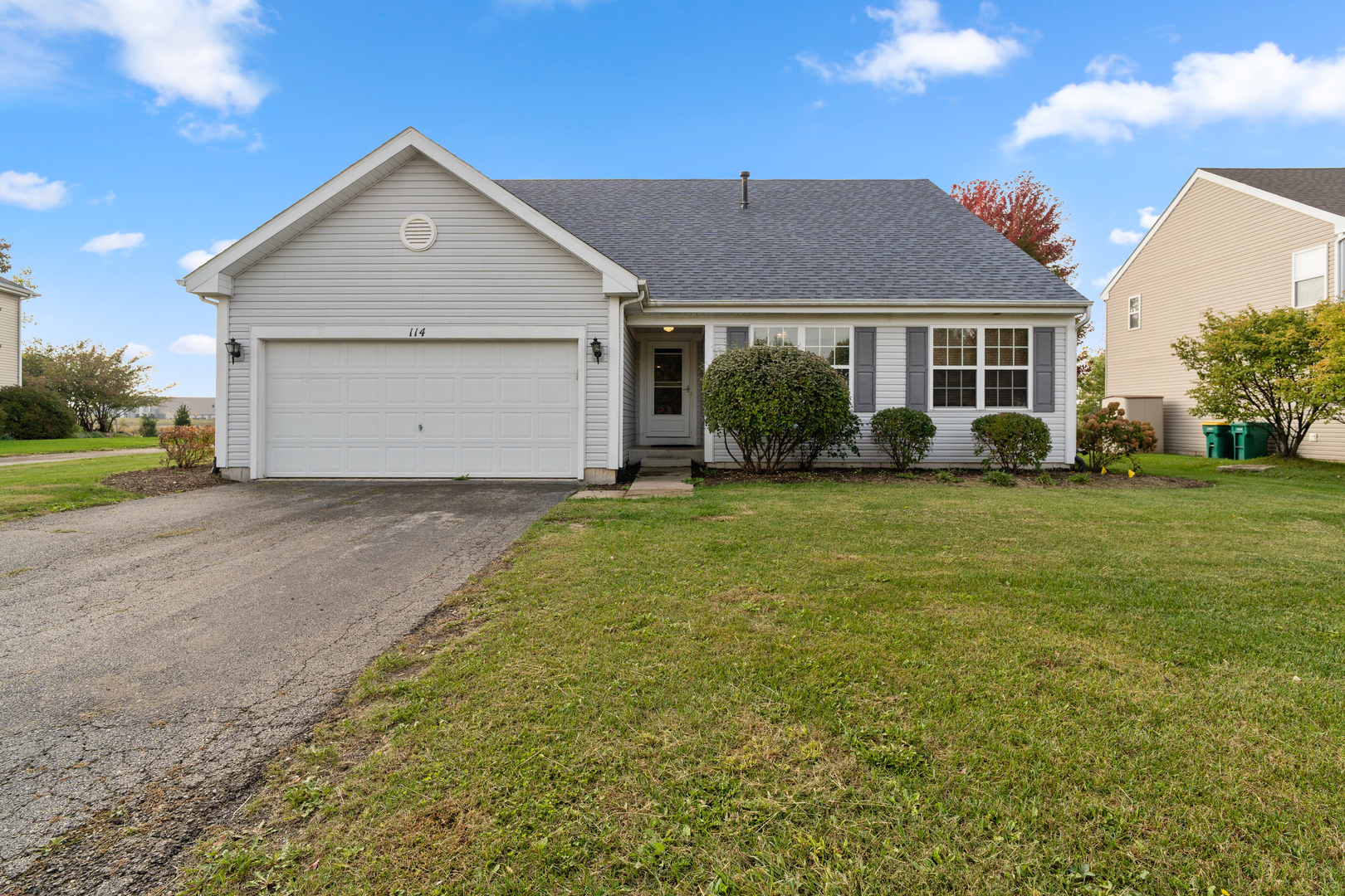 114 International Way Joliet, IL 60421 - Photo 2 of 31 a front view of a house with a yard and garage