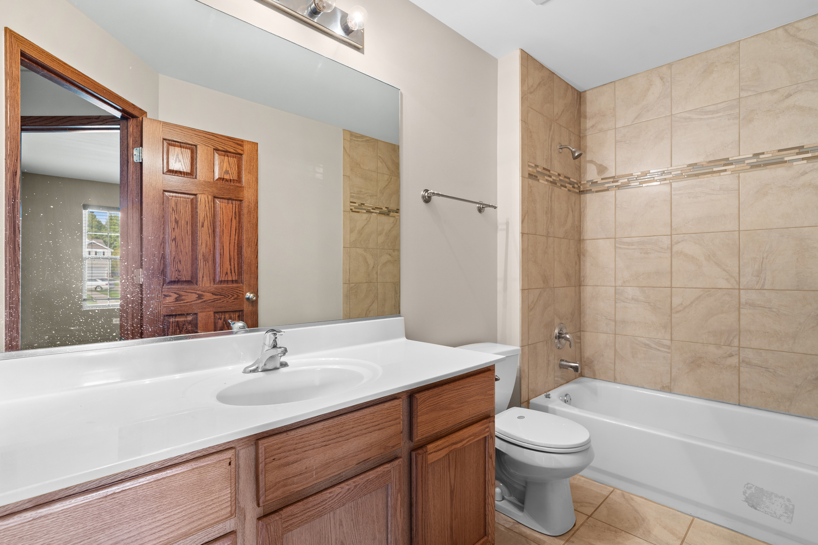 114 International Way Joliet, IL 60421 - Photo 22 of 31 a bathroom with a sink a toilet and shower