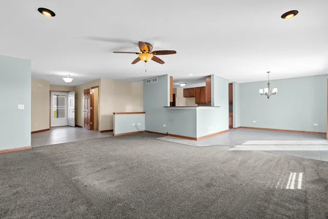 a view of a room with a kitchen and a sink