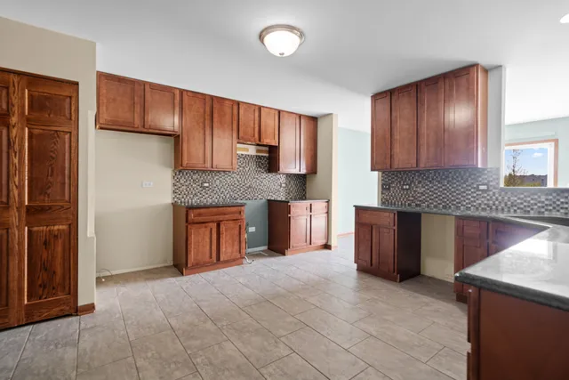a kitchen with granite countertop wooden cabinets and a stainless steel appliances