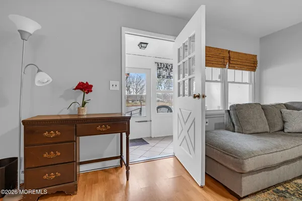a bedroom with a bed and a lamp on the dresser
