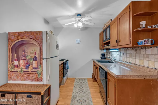 a kitchen with stainless steel appliances a stove a refrigerator and a microwave