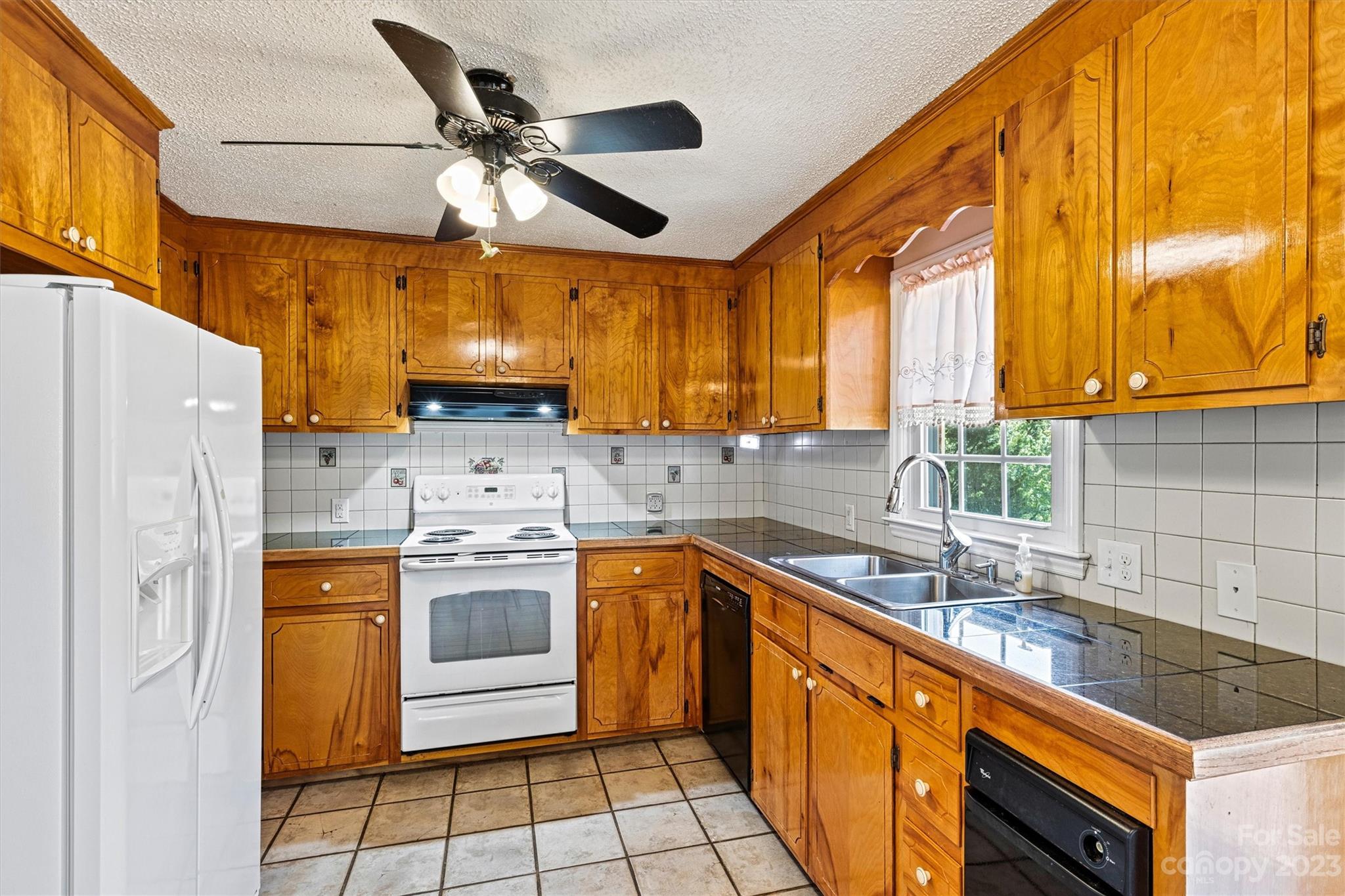5327 Lee Cline Road Conover, NC 28613 - Photo 12 of 36 a kitchen with stainless steel appliances granite countertop a sink a stove and refrigerator