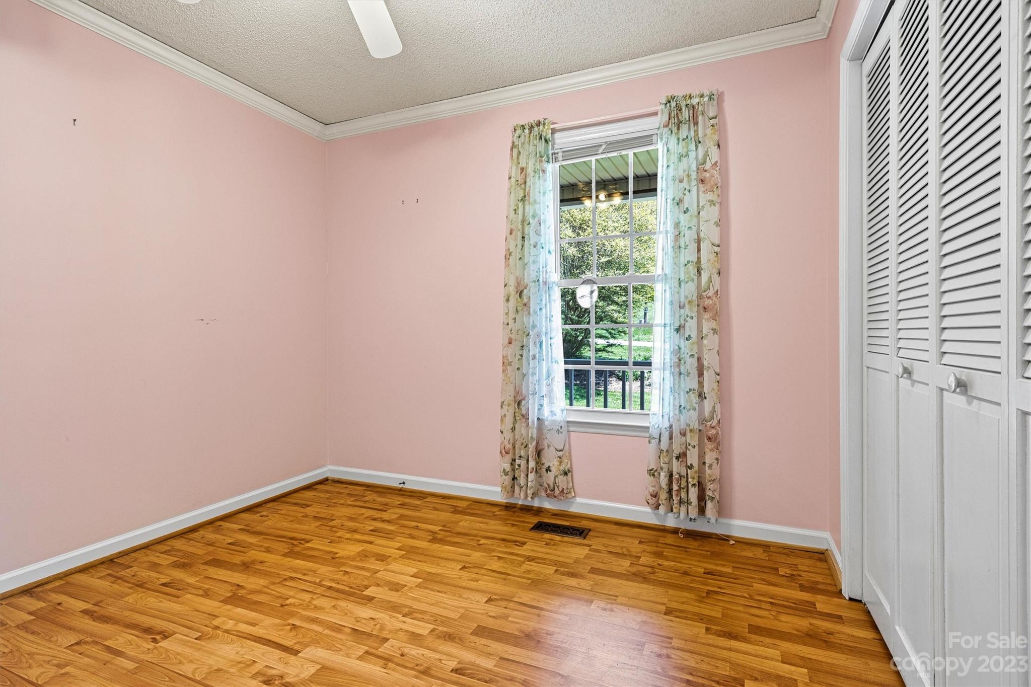 5327 Lee Cline Road Conover, NC 28613 - Photo 26 of 36 a view of empty room with wooden floor and fan