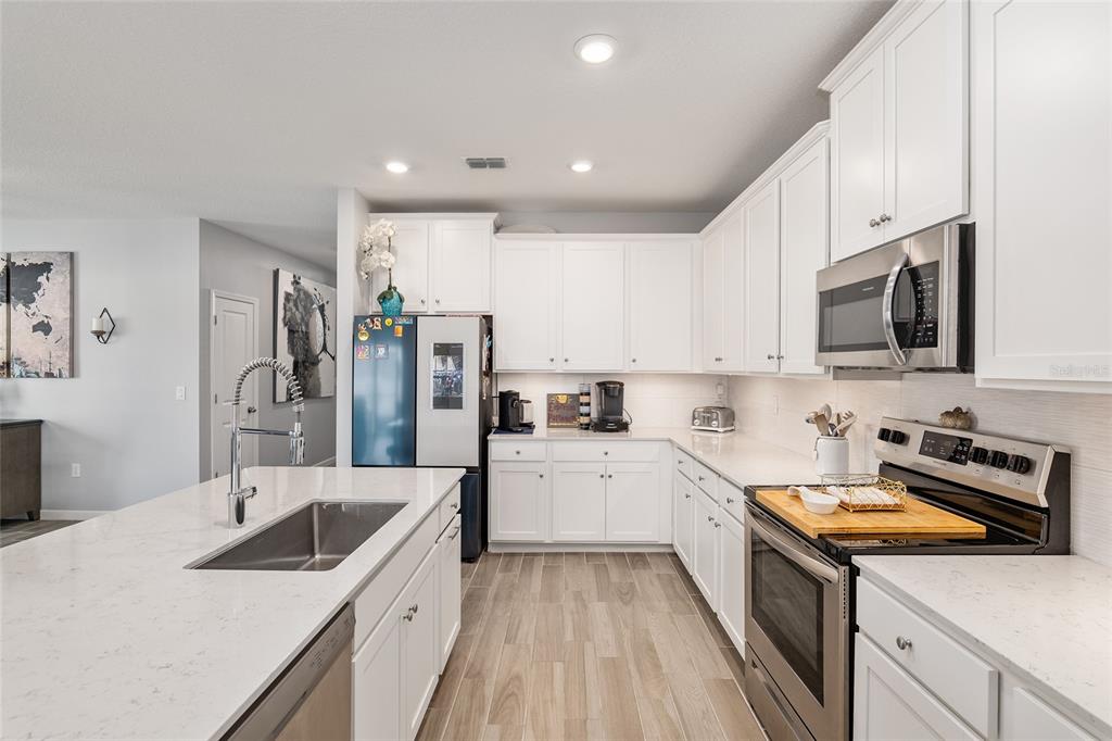 5688 Southwest 92nd Place Ocala, FL 34476 - Photo 21 of 54 a kitchen with a sink stove top oven and refrigerator