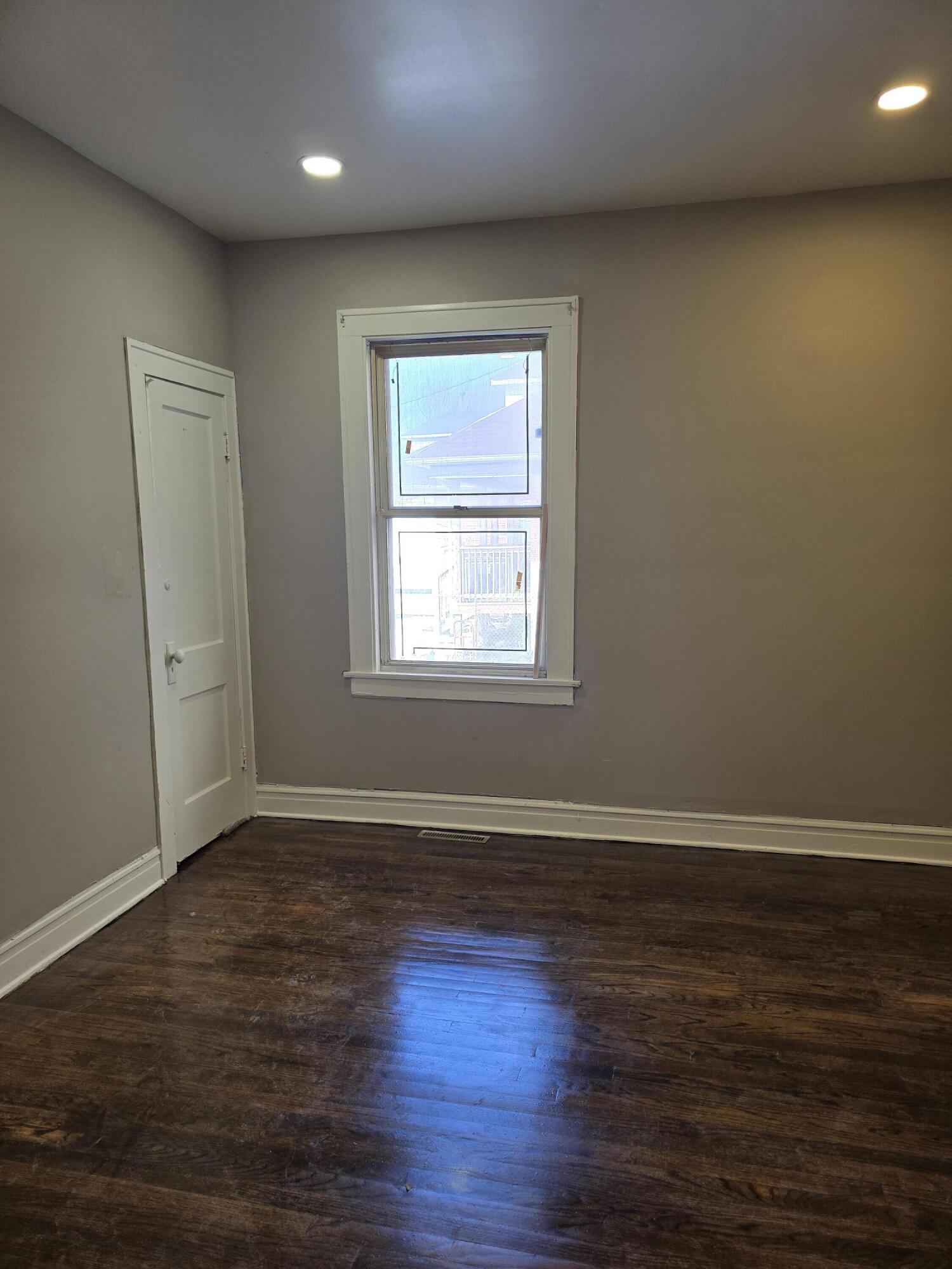 1168 Fillmore Street Gary, IN 46407 - Photo 11 of 22 an empty room with wooden floor and windows