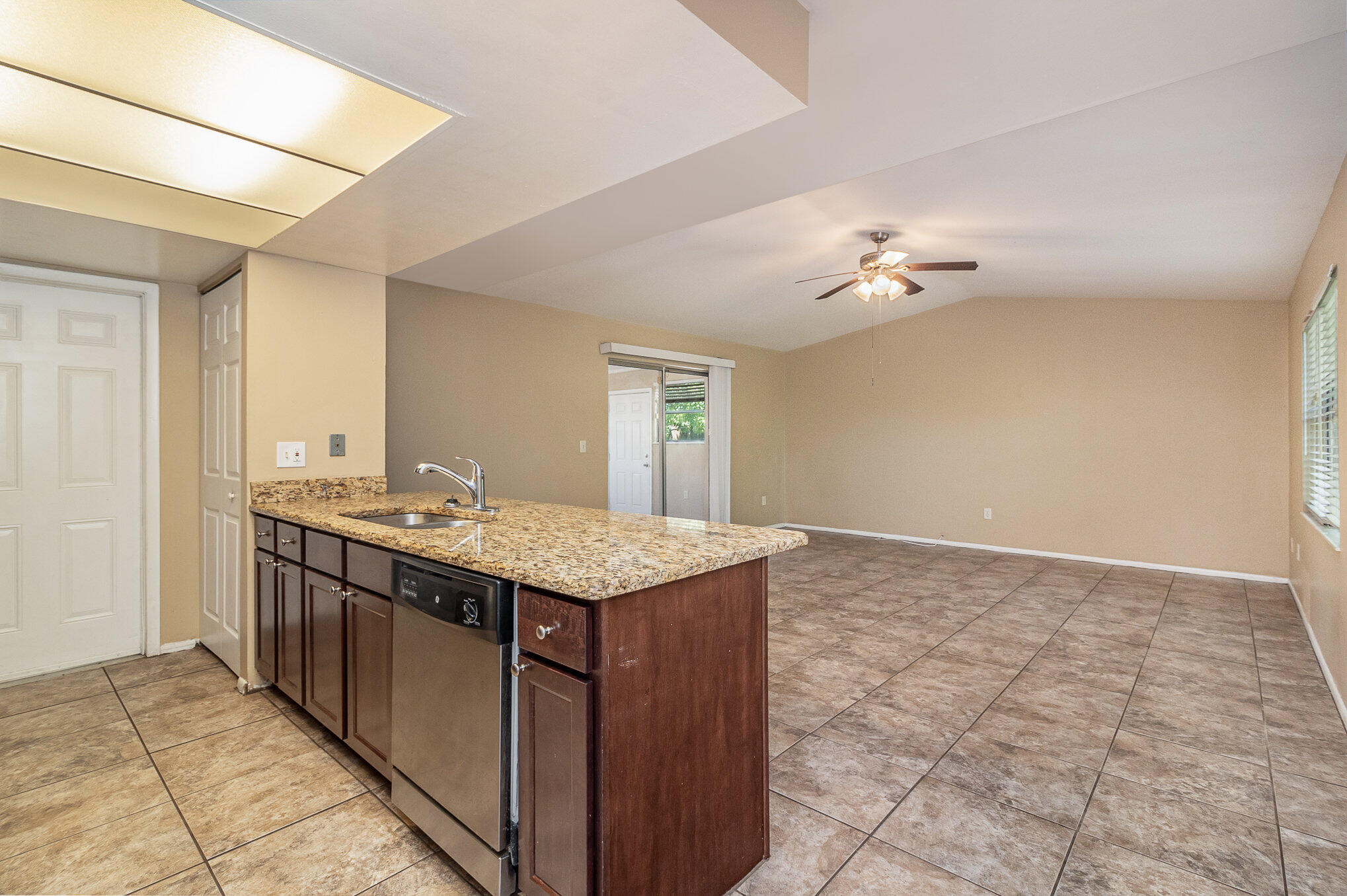 635 Croton Road Melbourne, FL 32935 - Photo 9 of 22 a kitchen with a sink a stove cabinets and entryway
