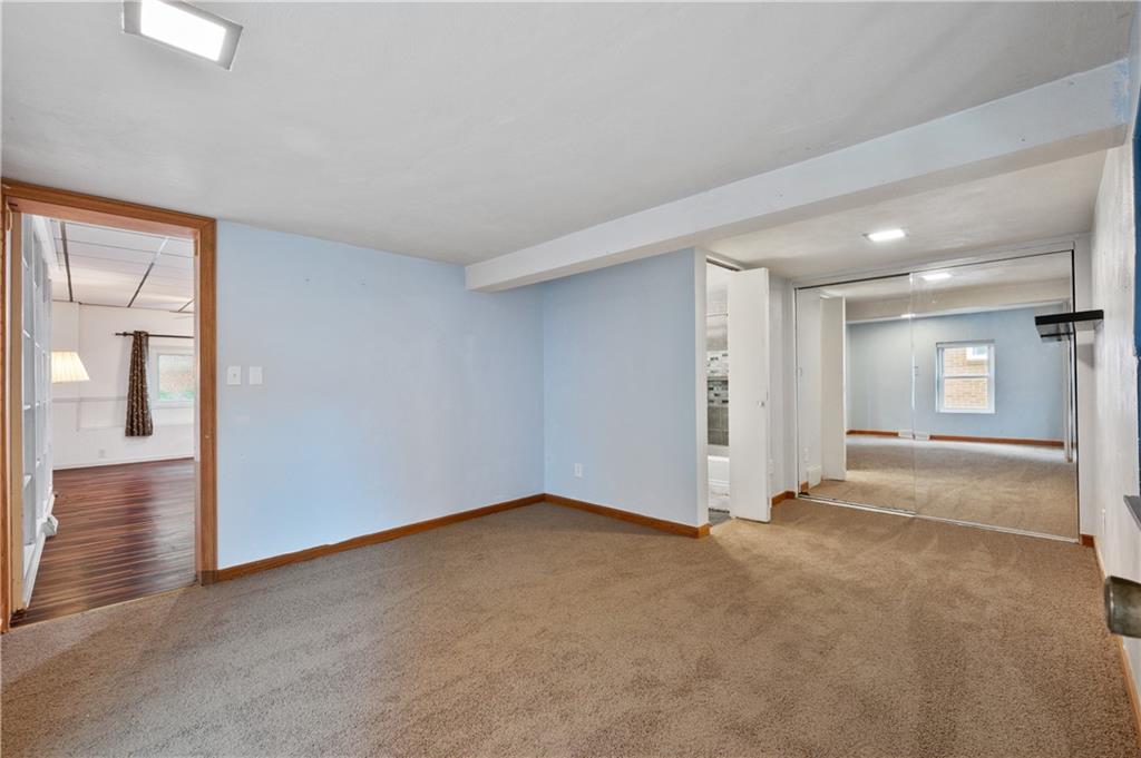 744 Lincoln Avenue Springdale, PA 15144 - Photo 12 of 26 an empty room with windows and entrance to other room