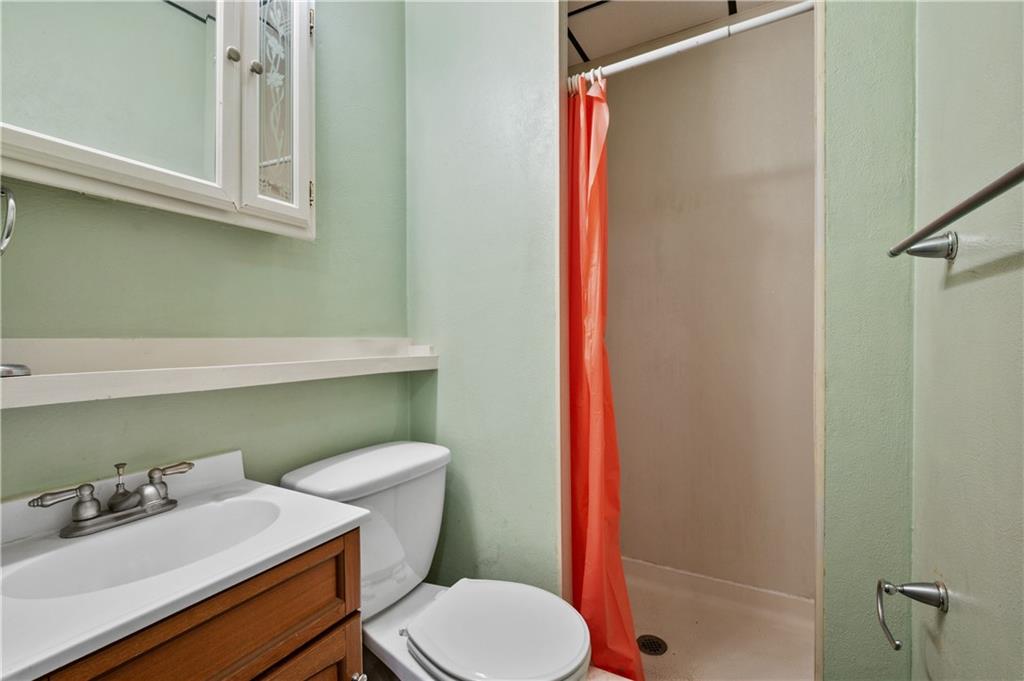 744 Lincoln Avenue Springdale, PA 15144 - Photo 22 of 26 a bathroom with a sink a toilet and shower