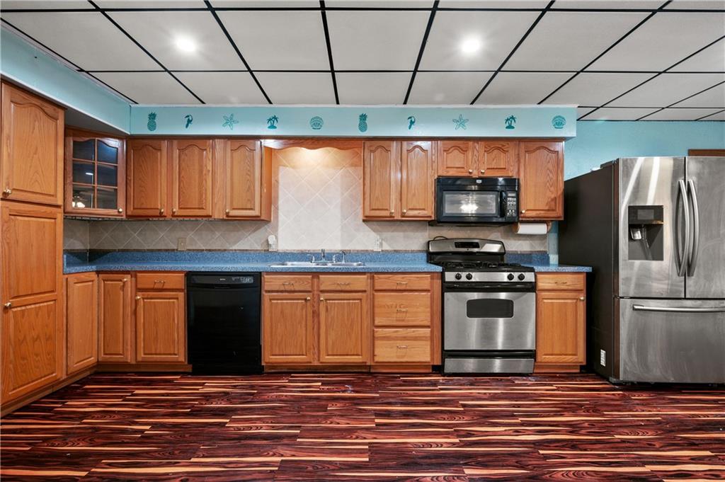 744 Lincoln Avenue Springdale, PA 15144 - Photo 4 of 26 a kitchen with stainless steel appliances granite countertop a refrigerator and a stove top oven