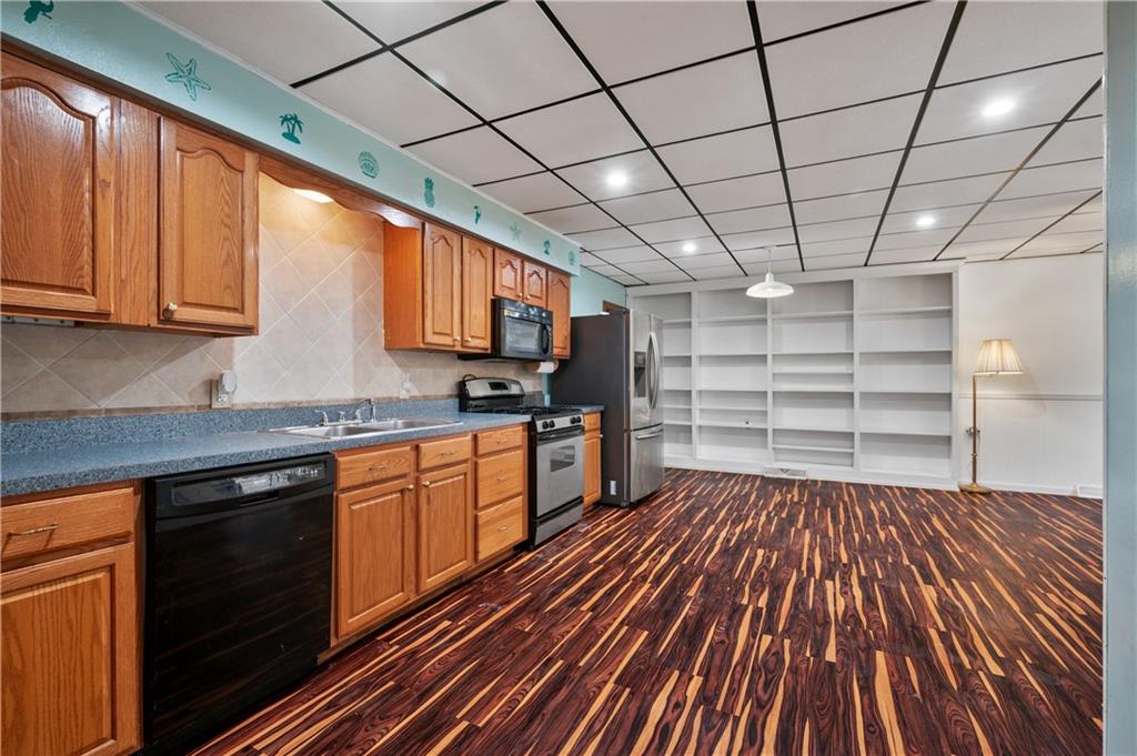 744 Lincoln Avenue Springdale, PA 15144 - Photo 5 of 26 a kitchen with cabinets and wooden floor