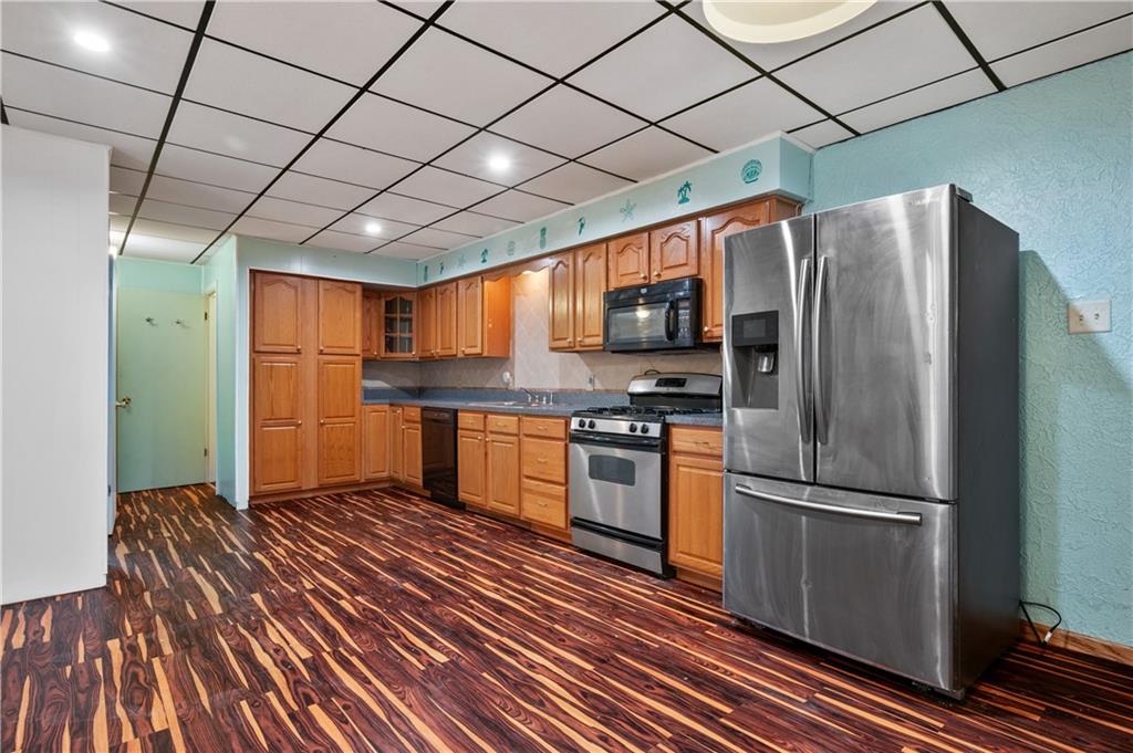 744 Lincoln Avenue Springdale, PA 15144 - Photo 6 of 26 a kitchen with stainless steel appliances granite countertop a refrigerator and a stove top oven