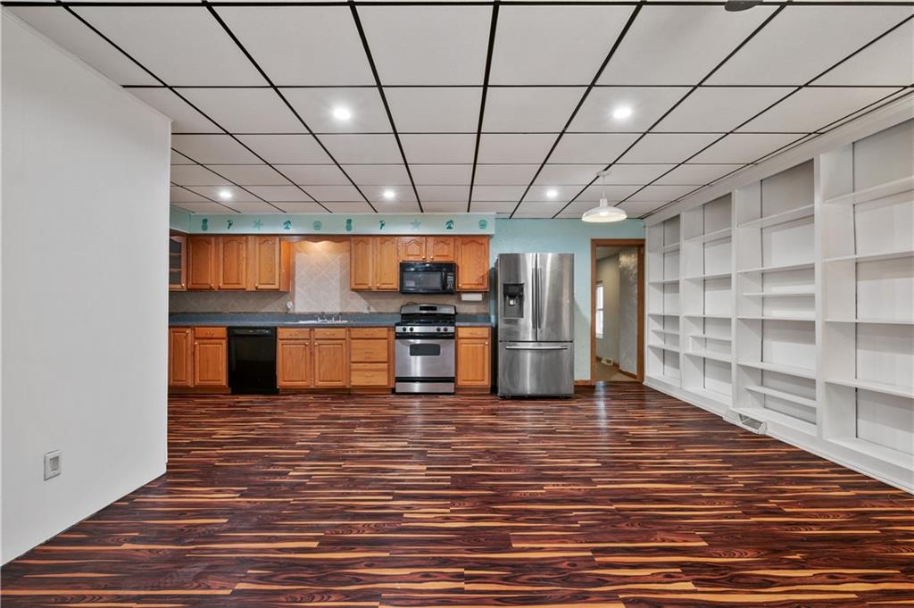 744 Lincoln Avenue Springdale, PA 15144 - Photo 7 of 26 a room with stainless steel appliances wooden floor and chandelier