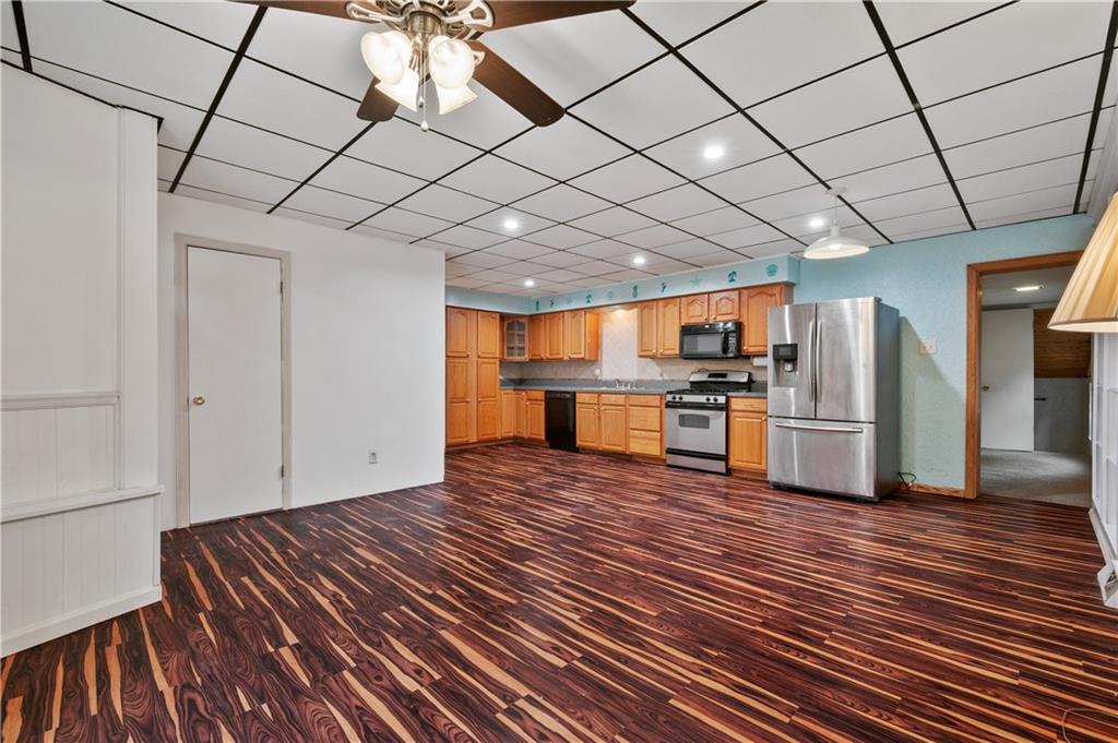 744 Lincoln Avenue Springdale, PA 15144 - Photo 8 of 26 a view of kitchen with furniture and wooden floor