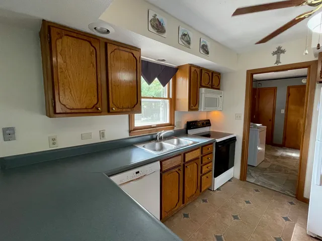a kitchen with a sink stove and cabinets