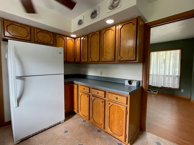 a kitchen with stainless steel appliances granite countertop a refrigerator a sink and a stove