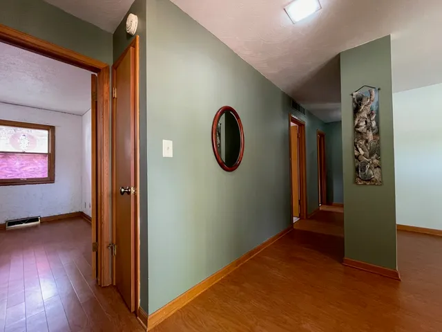 a view of a room with wooden floor and a window