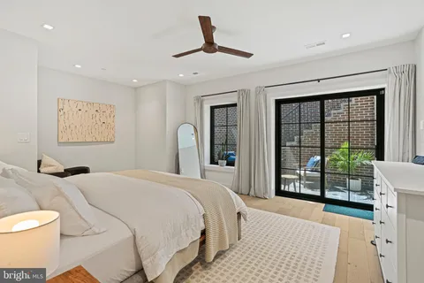 a bedroom with a large bed and a large window