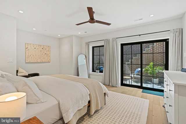 a bedroom with a large bed and a large window