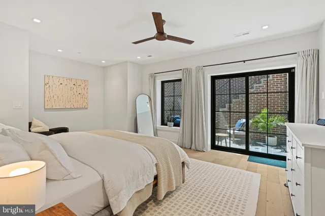 a bedroom with a large bed and a large window