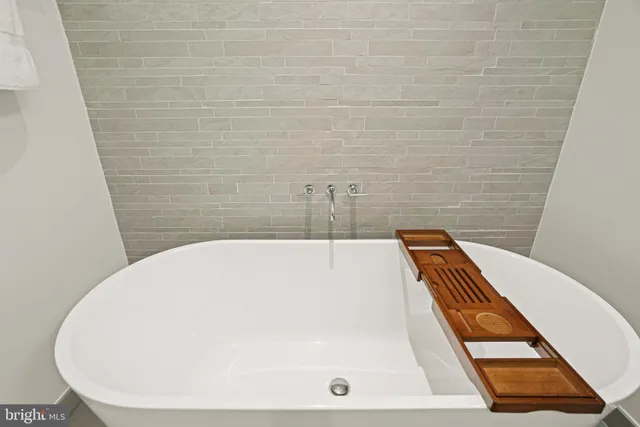 a white bath tub sitting in a bathroom