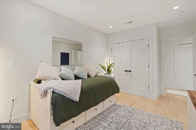 a bedroom with a bed and a dresser