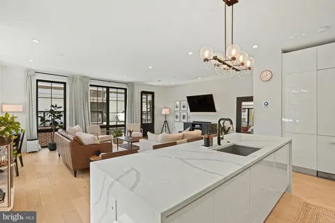 a large living room with large couches and flat tv screen