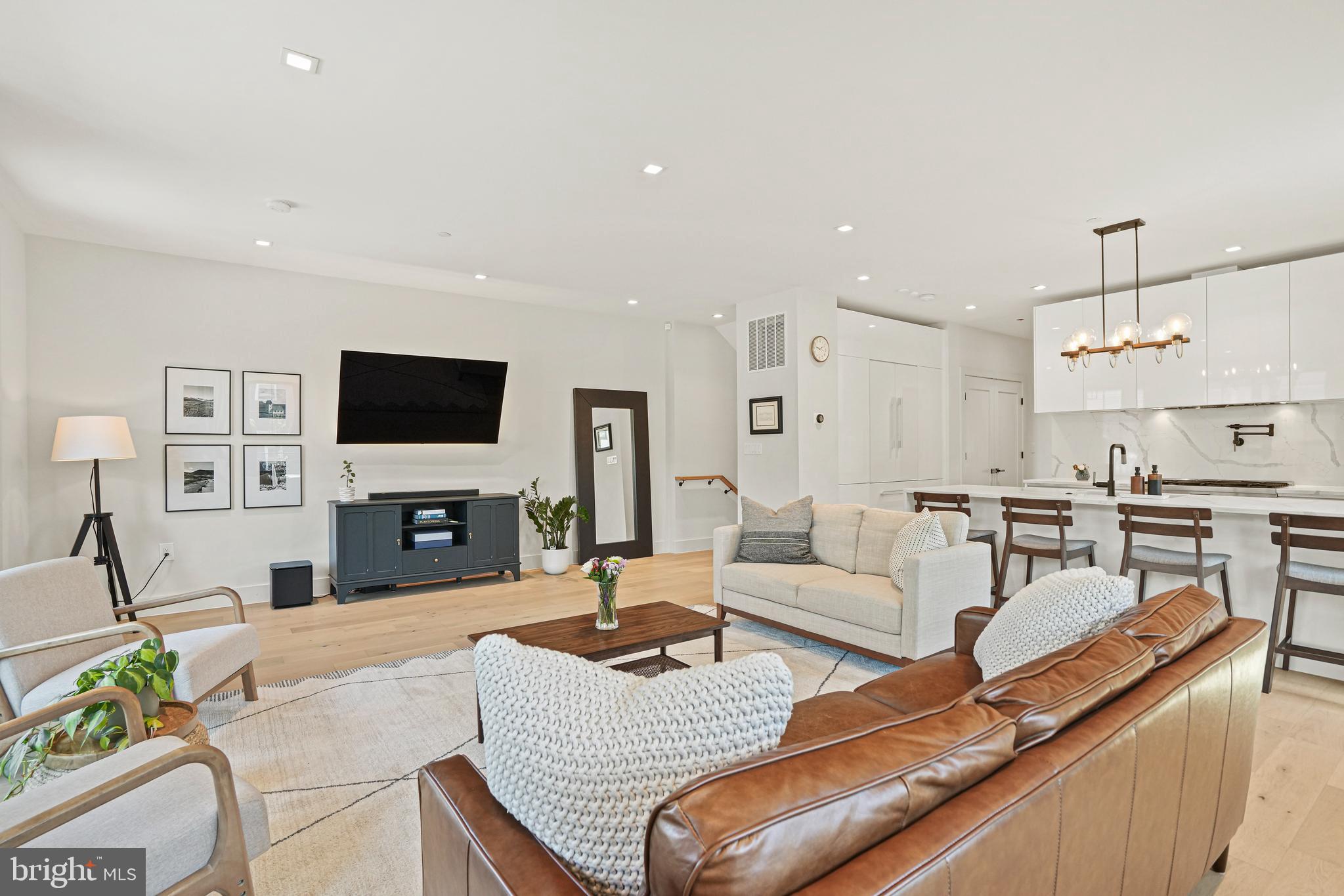 2100 4th Street Northeast, Unit 1 Washington, DC 20002 - Photo 10 of 34 a living room with furniture a flat screen tv and kitchen view