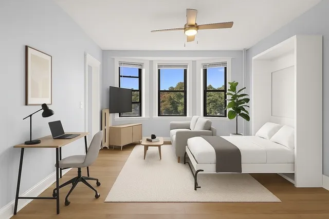 a bedroom with a bed and large windows