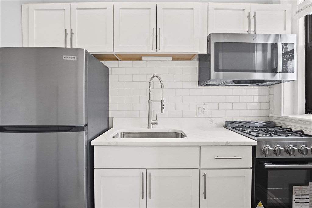 285 Lynn Shore Drive, Unit 508 Lynn, MA 01902 - Photo 2 of 18 a kitchen with stainless steel appliances a refrigerator stove and microwave