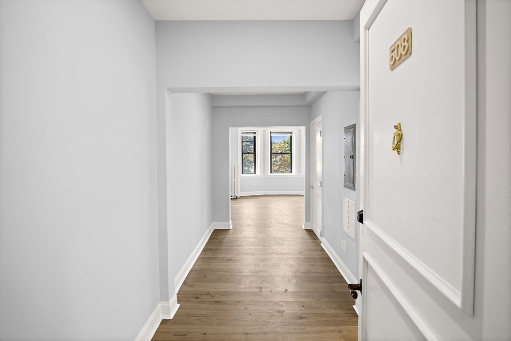 285 Lynn Shore Drive, Unit 508 Lynn, MA 01902 - Photo 3 of 18 a view of a hallway with wooden floor and staircase