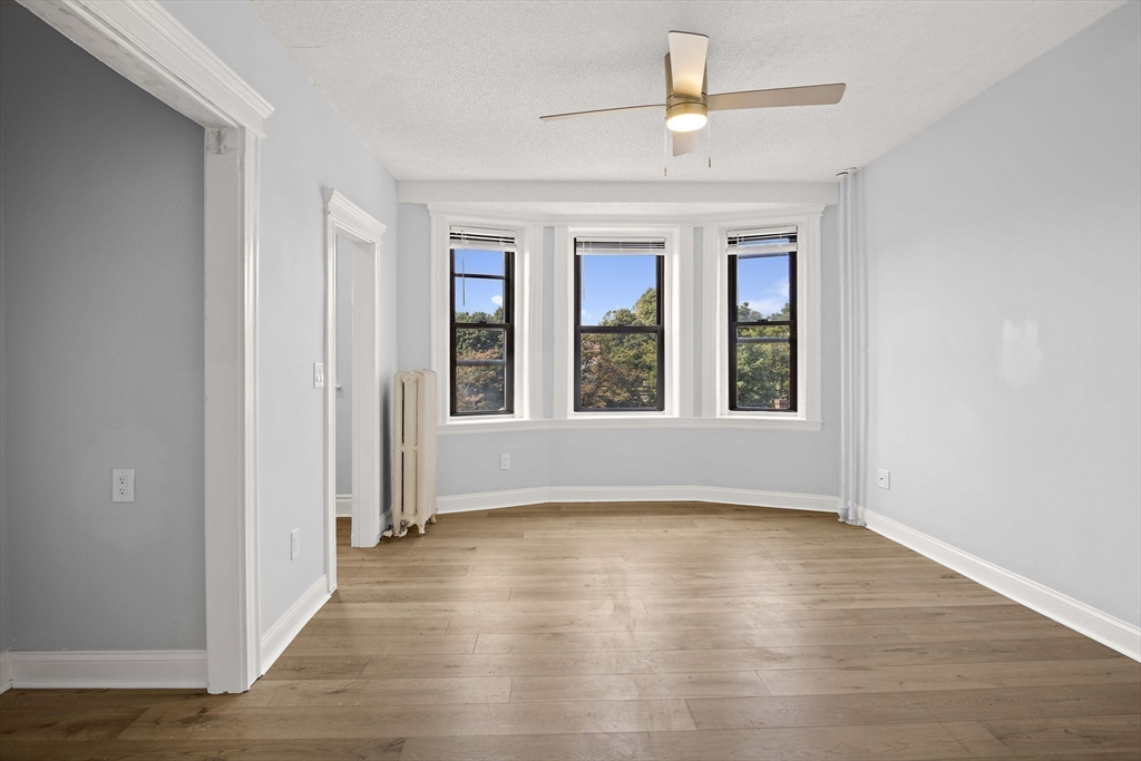 285 Lynn Shore Drive, Unit 508 Lynn, MA 01902 - Photo 6 of 18 wooden floor in an empty room with a window