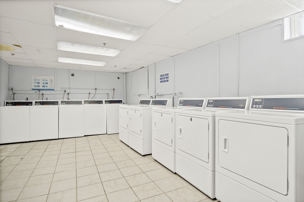 285 Lynn Shore Drive, Unit 508 Lynn, MA 01902 - Photo 10 of 18 a kitchen with white cabinets a sink and white appliances