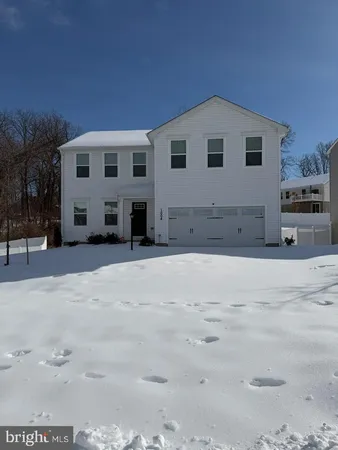 a large white house with a large tree in front of it