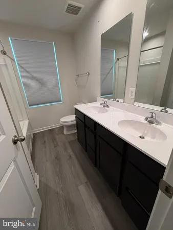 a bathroom with a sink a mirror and a toilet