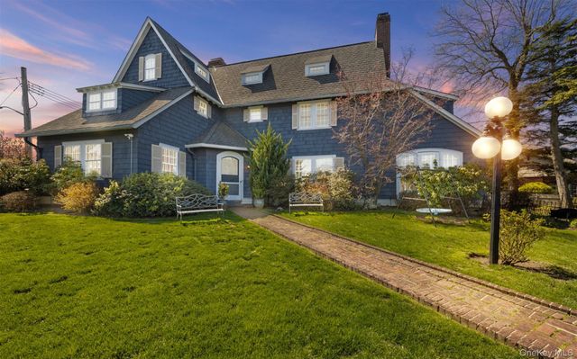 a front view of house with yard and green space